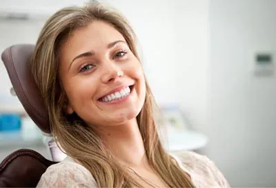 woman showing off her newly whitened smile thanks to services from Pacific Coast Dentistry