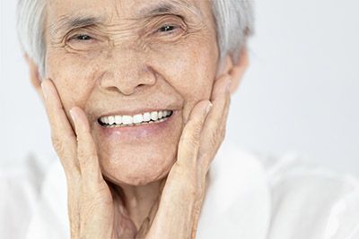 woman very happy with her new dentures from Pacific Coast Dentistry in Paso Robles, CA