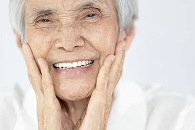 woman very happy with her new dentures from Pacific Coast Dentistry in Paso Robles, CA
