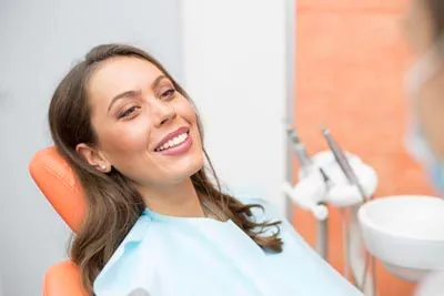 woman smiling after getting an oral surgery procedure at Pacific Coast Dentistry in Paso Robles, CA