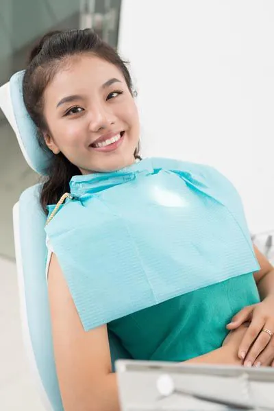 woman smiling in the dental chair at Pacific Coast Dentistry in Paso Robles, CA