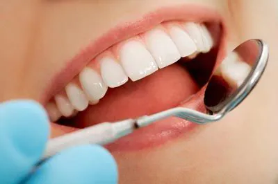 closeup of a patient receiving a dental checkup at Pacific Coast Dentistry in Paso Robles, CA
